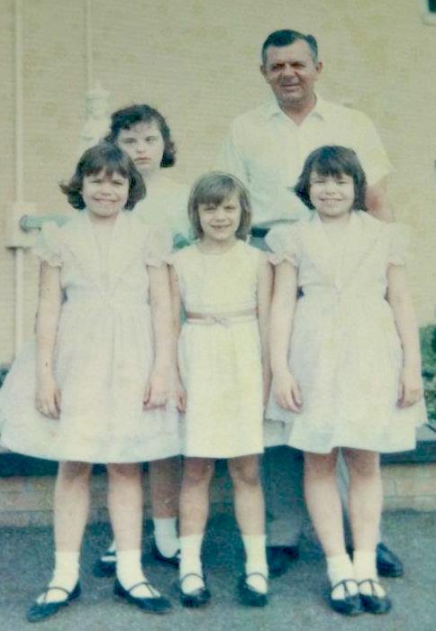 4 girls standing with father