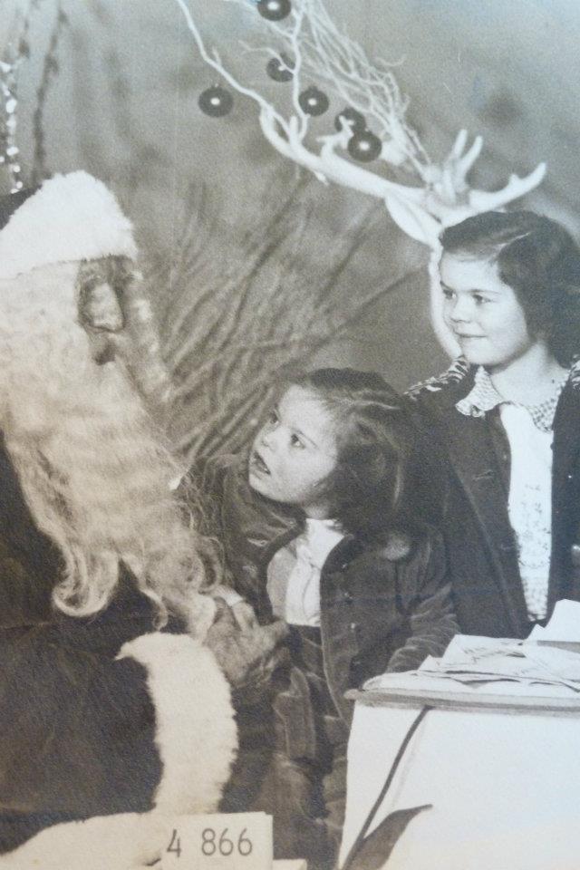 Child with Down Syndrome looking up at Santa