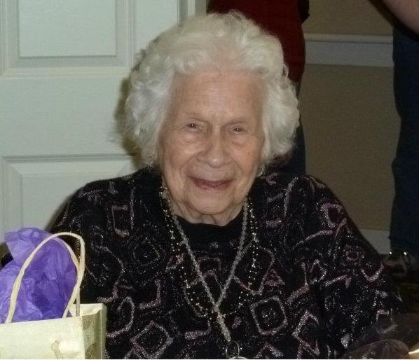 White haired adult woman smiling at camera 